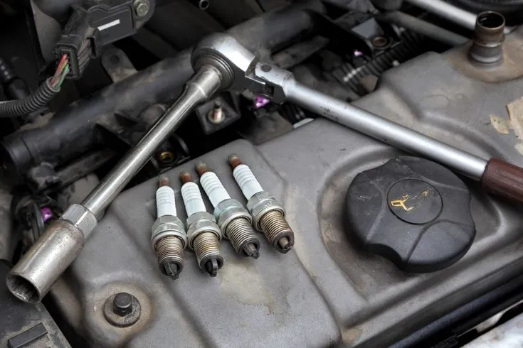 The Spark Plug Symptoms That Explain Why Your Car Hesitates When Accelerating